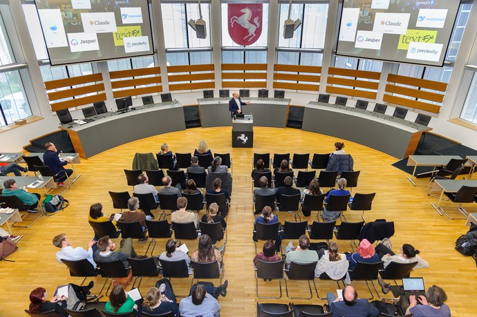 Die Teilnehmenden verfolgen im Plenarsaal des LWL-Landeshauses die Keynote „KI trifft Kultur? Die Zukunft ist jetzt!“ von Prof. Michael Schwertel