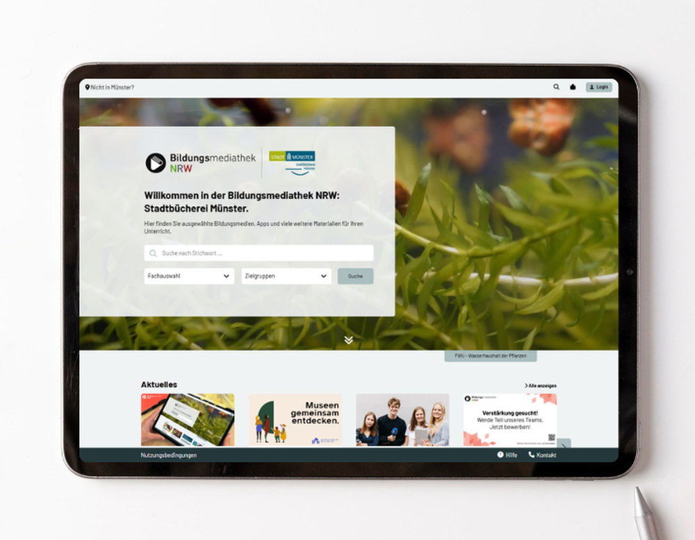 Ein Tablet liegt auf einem Tisch und zeigt die Startseite der Bildungsmediathek NRW.